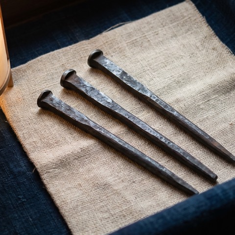 Bō-shuriken, spike — six, photographed on unbleached hemp cloth.
