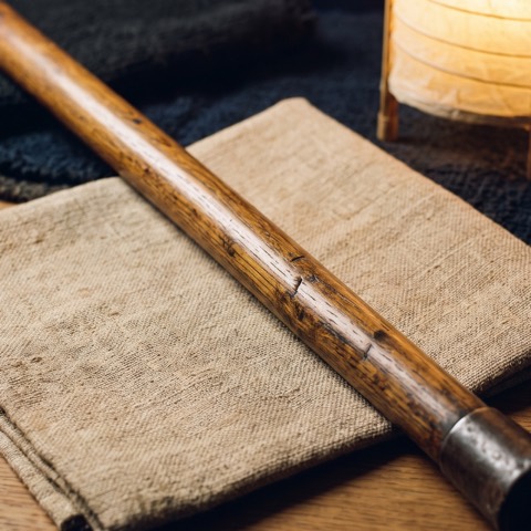 Shikomi-zue — the staff that is not one, photographed on unbleached hemp cloth.